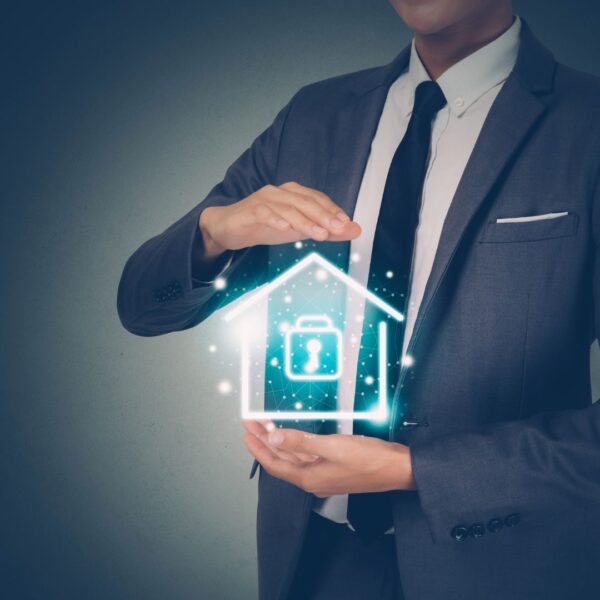 Business man with graphic of a house with a lock in his hands