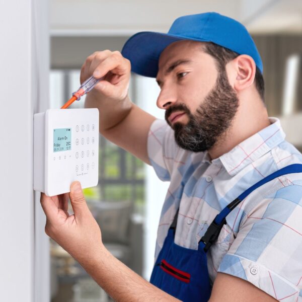 Technician installing a security system